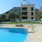 View across pool & garden with mountains in backgound
